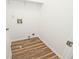 Functional laundry room features wood flooring and essential hookups, offering convenience and practicality at 11320 Lynchburg Way, Indianapolis, IN 46229
