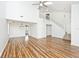 Bright living room features high ceilings, a ceiling fan, wood flooring, and staircase leading to the upper level at 11320 Lynchburg Way, Indianapolis, IN 46229