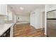 Open-concept living room featuring wood floors, natural light, and seamless flow into the kitchen at 11320 Lynchburg Way, Indianapolis, IN 46229