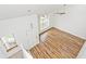 Aerial view showcases the spacious living room with its wood floors, staircase, and large windows at 11320 Lynchburg Way, Indianapolis, IN 46229