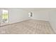 Open living room with neutral carpet, white walls, and glass door access to the backyard at 11320 Lynchburg Way, Indianapolis, IN 46229