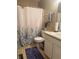 Traditional bathroom featuring a floral shower curtain, ceramic toilet, and vanity with integrated sink at 11632 Coastal Way, Indianapolis, IN 46229