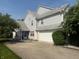 Two story home featuring neutral siding, attached two car garage, mature landscape, and a concrete driveway at 11632 Coastal Way, Indianapolis, IN 46229