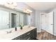 This bathroom features a double vanity, a large mirror, and wood-look floors, providing style and functionality at 117 Sawgrass Ct, Lebanon, IN 46052