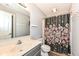Updated bathroom featuring modern vanity, wood look floors, and shower with decorative curtain at 117 Sawgrass Ct, Lebanon, IN 46052