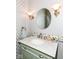 Charming powder room featuring a modern vanity, elegant mirror, and decorative lighting at 117 Sawgrass Ct, Lebanon, IN 46052