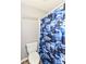 This bathroom features a commode and a blue camouflage-themed shower curtain, providing privacy and personality at 117 Sawgrass Ct, Lebanon, IN 46052