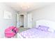 This bedroom has neutral gray walls, a decorative pink chair, and a purple bedspread and is ready for move-in at 117 Sawgrass Ct, Lebanon, IN 46052