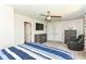 This bedroom features neutral-toned walls and carpet, a ceiling fan, and a large window for plenty of natural light at 117 Sawgrass Ct, Lebanon, IN 46052