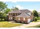 Beautiful two-story brick home with a well-manicured lawn, mature trees, and a grand entrance at 117 Sawgrass Ct, Lebanon, IN 46052