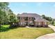 Beautiful two-story brick home with a well-manicured lawn, mature trees, and a grand entrance at 117 Sawgrass Ct, Lebanon, IN 46052