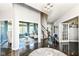 Hallway with dark wood floors, gray walls, white trim and views into well decorated sitting room at 117 Sawgrass Ct, Lebanon, IN 46052