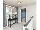 A light-filled hallway with a dark console table sits at the top of a staircase, leading to the home's bedrooms at 117 Sawgrass Ct, Lebanon, IN 46052