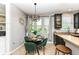Sun-filled breakfast nook with modern lighting and a view of the lush outdoors at 117 Sawgrass Ct, Lebanon, IN 46052
