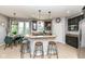 Bright eat-in kitchen featuring a large island, granite countertops, and dark cabinetry at 117 Sawgrass Ct, Lebanon, IN 46052