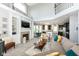 Open-concept living room with a fireplace, built-in shelving, and seamless transition to the kitchen and dining area at 117 Sawgrass Ct, Lebanon, IN 46052