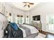 Light-filled main bedroom boasts a modern ceiling fan and backyard access at 117 Sawgrass Ct, Lebanon, IN 46052