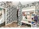 Well-organized mudroom featuring shelving, storage, and stylish floral wallpaper at 117 Sawgrass Ct, Lebanon, IN 46052
