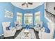 Bright sitting area with high ceilings, neutral-toned chairs, and large windows at 117 Sawgrass Ct, Lebanon, IN 46052