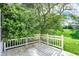 Wood-floored porch surrounded by a green yard, lawn, and trees at 11961 Driftstone Dr, Fishers, IN 46037