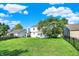 View of a large and green back yard with mature trees and a fence at 11961 Driftstone Dr, Fishers, IN 46037