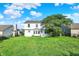 Back yard with lush green grass, mature tree, and privacy fence at 11961 Driftstone Dr, Fishers, IN 46037