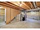 Unfinished basement features exposed rafters, cement floors, and a water heater at 11961 Driftstone Dr, Fishers, IN 46037
