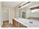 A double-vanity bathroom features a large mirror and tile floor at 11961 Driftstone Dr, Fishers, IN 46037
