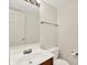 This half-bathroom features a white sink, wood cabinet and modern fixtures at 11961 Driftstone Dr, Fishers, IN 46037