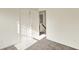 Bedroom featuring neutral carpet, white walls and trim, and an open closet with a staircase view at 11961 Driftstone Dr, Fishers, IN 46037