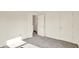 Bright bedroom featuring neutral carpet, white walls, and an open closet with white trim at 11961 Driftstone Dr, Fishers, IN 46037