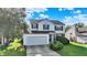 Traditional two-story home with a two-car garage and brick details in the front at 11961 Driftstone Dr, Fishers, IN 46037