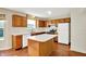 Well-lit kitchen featuring oak cabinets, laminate countertops, and essential appliances at 11961 Driftstone Dr, Fishers, IN 46037