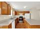 Kitchen with a stainless steel double sink, white countertops, and wood cabinets at 11961 Driftstone Dr, Fishers, IN 46037