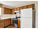 Close-up of a kitchen area showcasing wood cabinets and stainless-steel oven at 11961 Driftstone Dr, Fishers, IN 46037