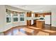 Bright kitchen with wood cabinets, a center island, and a bay window overlooking the yard at 11961 Driftstone Dr, Fishers, IN 46037