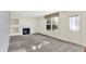 Spacious living room featuring carpeted floors, a fireplace, and natural light at 11961 Driftstone Dr, Fishers, IN 46037