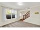 Spacious living area featuring natural light and access to a staircase at 11961 Driftstone Dr, Fishers, IN 46037