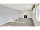 Bright and open living room featuring a fireplace and carpeted floors at 11961 Driftstone Dr, Fishers, IN 46037