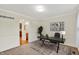 Functional home office with neutral paint, built-in shelving, and an adjacent bathroom at 11961 Driftstone Dr, Fishers, IN 46037