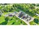 Aerial view of community playground with slides, swings, and a lush green landscape at 11961 Driftstone Dr, Fishers, IN 46037