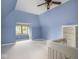 Attic bedroom with blue walls, carpet and an exterior view from a window at 1207 Pickwick Pl, Indianapolis, IN 46208