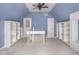 Attic space showcasing bright blue walls, built-in shelving, and carpeted flooring at 1207 Pickwick Pl, Indianapolis, IN 46208