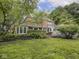 Backyard view featuring the home, patio seating, and landscaping at 1207 Pickwick Pl, Indianapolis, IN 46208
