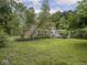 Expansive backyard with well-manicured lawn and mature shade trees at 1207 Pickwick Pl, Indianapolis, IN 46208
