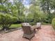 Backyard with brick patio featuring outdoor seating, lush greenery, and serene ambiance at 1207 Pickwick Pl, Indianapolis, IN 46208