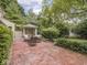Inviting backyard featuring a brick patio, lush greenery, and cozy gazebo at 1207 Pickwick Pl, Indianapolis, IN 46208