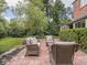 Spacious brick patio with seating area surrounded by lush, mature landscaping at 1207 Pickwick Pl, Indianapolis, IN 46208