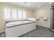 Large soaking tub with abundant natural light and tile surround at 1207 Pickwick Pl, Indianapolis, IN 46208