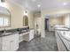 Bright bathroom with a double sink vanity with granite countertop, a tub and a walk-in shower at 1207 Pickwick Pl, Indianapolis, IN 46208